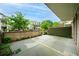 Exterior showcasing a landscaped backyard with brick walls and trimmed shrubs, ensuring a private outdoor oasis at 130 Forrest Aly, Roswell, GA 30075