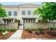 Inviting two-story townhome with brick facade, shutters, and lush landscaping at 130 Forrest Aly, Roswell, GA 30075