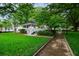 Scenic view of a charming white gazebo nestled among lush trees and a well-manicured lawn at 130 Forrest Aly, Roswell, GA 30075