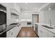 Modern kitchen features stainless steel appliances, white cabinetry, and hardwood floors at 130 Forrest Aly, Roswell, GA 30075