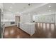 Open concept kitchen with island, stainless appliances, and seamless flow to the living area at 130 Forrest Aly, Roswell, GA 30075