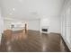 Spacious living room with hardwood floors, fireplace, and open layout to kitchen at 130 Forrest Aly, Roswell, GA 30075