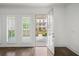 Bright, elegant living room showcasing beautiful wood floors, plantation shutters, and exterior views at 130 Forrest Aly, Roswell, GA 30075