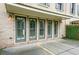 Outdoor patio area featuring door to the home, brick detailing, and privacy wall at 130 Forrest Aly, Roswell, GA 30075