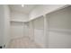 A well-organized walk-in closet with custom shelving and hanging rods for ample storage at 130 Forrest Aly, Roswell, GA 30075