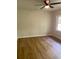 Bright bedroom with wood-look floors, neutral walls, and a ceiling fan at 3080 Hogan Sw Rd, Atlanta, GA 30331