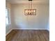 Bright dining room features stylish chandelier and beautiful wood-look flooring at 3080 Hogan Sw Rd, Atlanta, GA 30331