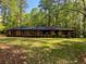 Ranch-style brick home with mature trees and landscaping creating a serene and private setting at 3080 Hogan Sw Rd, Atlanta, GA 30331