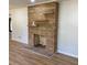 Close up of the stone fireplace and new hardwood floors in the living room at 3080 Hogan Sw Rd, Atlanta, GA 30331