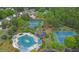 Aerial view of community amenities: pool, tennis courts, clubhouse, and surrounding houses at 5155 Amberden Hall Dr, Suwanee, GA 30024