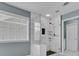 Bathroom with large shower with glass door and marble tile at 5155 Amberden Hall Dr, Suwanee, GA 30024