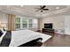 Bright bedroom featuring large windows, a ceiling fan, and hardwood floors at 5155 Amberden Hall Dr, Suwanee, GA 30024