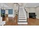 Grand foyer featuring a staircase, hardwood floors, and elegant trim work leading to living areas at 5155 Amberden Hall Dr, Suwanee, GA 30024