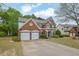 Charming brick home with a two-car garage and well-manicured lawn in a suburban setting at 5155 Amberden Hall Dr, Suwanee, GA 30024