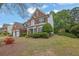 Beautiful brick home featuring a two-car garage and lush landscaping on a well-maintained lawn at 5155 Amberden Hall Dr, Suwanee, GA 30024