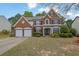 Attractive brick home with manicured lawn, symmetrical design, and inviting curb appeal at 5155 Amberden Hall Dr, Suwanee, GA 30024