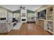 Cozy living area showcasing a fireplace, hardwood floors, and expansive windows at 5155 Amberden Hall Dr, Suwanee, GA 30024
