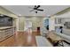 Inviting living room boasts hardwood floors, neutral walls, a ceiling fan, and plenty of natural light at 5155 Amberden Hall Dr, Suwanee, GA 30024