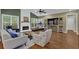 Bright living room features fireplace, vaulted ceilings, and hardwood flooring, with a treadmill and entertainment center at 5155 Amberden Hall Dr, Suwanee, GA 30024