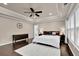 Main bedroom featuring hardwood floors, a tray ceiling, and bright windows at 5155 Amberden Hall Dr, Suwanee, GA 30024