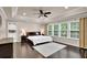 Spacious main bedroom featuring tray ceiling, hardwood floors, and bright windows at 5155 Amberden Hall Dr, Suwanee, GA 30024