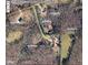 Aerial view of the property and surrounding acreage in a wooded area at 7180 Westray Rd, Cumming, GA 30028
