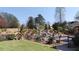 Landscaped backyard featuring a pool slide and well-maintained garden, great for entertaining at 7180 Westray Rd, Cumming, GA 30028
