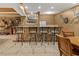 Bar area features stone accents, granite countertops, and ample seating at 7180 Westray Rd, Cumming, GA 30028