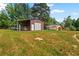 Functional barn with covered storage and fencing, suitable for various uses at 7180 Westray Rd, Cumming, GA 30028