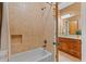 Full bathroom featuring a tub shower with beige tile and view of vanity at 7180 Westray Rd, Cumming, GA 30028