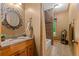 Bathroom with granite countertop, tile floors, and a shower-tub combo at 7180 Westray Rd, Cumming, GA 30028