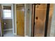 Bathroom featuring a glass-enclosed shower and neutral tile finishes at 7180 Westray Rd, Cumming, GA 30028
