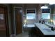 Well-lit bathroom with double sinks, garden tub, and tiled walls at 7180 Westray Rd, Cumming, GA 30028