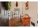 Warm entryway with hardwood floors, decorative bench, and open view to the living spaces at 7180 Westray Rd, Cumming, GA 30028