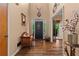 Welcoming entryway with hardwood floors, high ceilings, and decorative elements showcasing rustic charm at 7180 Westray Rd, Cumming, GA 30028