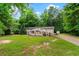 Well-maintained front yard with a charming home, a ramp, and a peaceful country setting at 7180 Westray Rd, Cumming, GA 30028