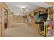 Spacious game room with a vintage arcade game and a large seating area at 7180 Westray Rd, Cumming, GA 30028