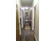 Long hallway with hardwood floors and multiple doorways at 7180 Westray Rd, Cumming, GA 30028