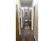 Inviting hallway featuring wood flooring, multiple doorways and decor at 7180 Westray Rd, Cumming, GA 30028