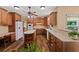 Open kitchen with wood cabinets, breakfast nook, large island, and stainless steel appliances at 7180 Westray Rd, Cumming, GA 30028