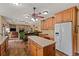 Kitchen with island overlooking living room and featuring stainless steel appliances and hardwood floors at 7180 Westray Rd, Cumming, GA 30028
