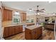 Kitchen featuring wood cabinetry, stainless appliances, and island with granite countertops at 7180 Westray Rd, Cumming, GA 30028