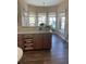 Bright kitchen with wooden cabinets, granite countertops, and a large window with seating at 7180 Westray Rd, Cumming, GA 30028