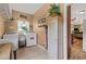 Well-organized laundry room offering a washer, dryer, cabinet storage and window at 7180 Westray Rd, Cumming, GA 30028