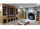 Cozy living room with stone fireplace and custom built-in shelving around room at 7180 Westray Rd, Cumming, GA 30028