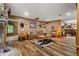 Spacious living room boasts hardwood floors, neutral paint, and stone fireplace at 7180 Westray Rd, Cumming, GA 30028