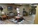 Comfortable living room with a leather couch, mounted animal heads, and wood flooring at 7180 Westray Rd, Cumming, GA 30028