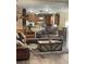 Cozy living room featuring a leather sofa, decorative pillows and a rustic storage trunk at 7180 Westray Rd, Cumming, GA 30028