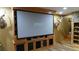 Living room with large projector screen and built-in shelves at 7180 Westray Rd, Cumming, GA 30028