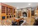 Cozy living room with fireplace, hardwood floors, and built-in shelves at 7180 Westray Rd, Cumming, GA 30028